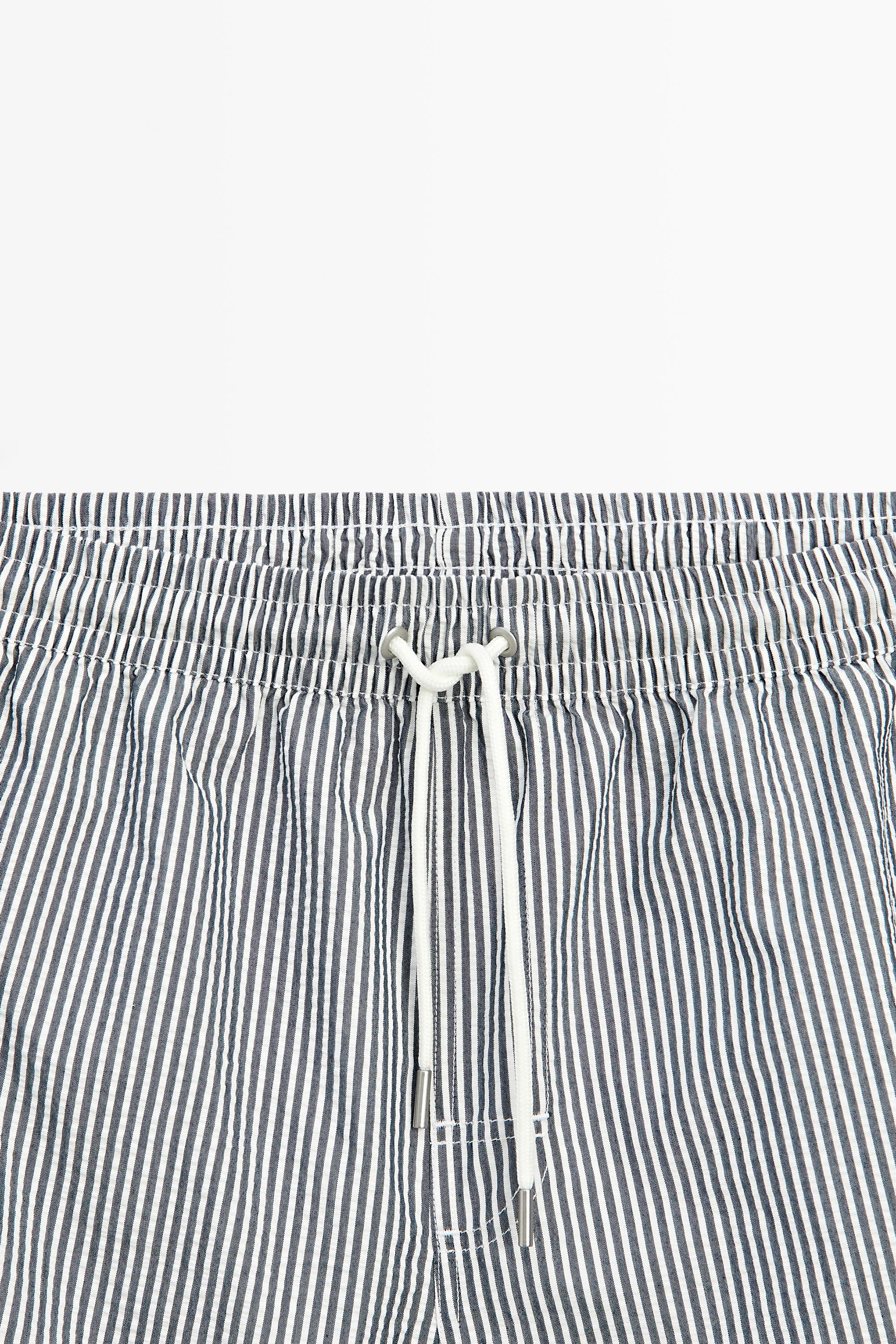 Swimming trunks with striped details